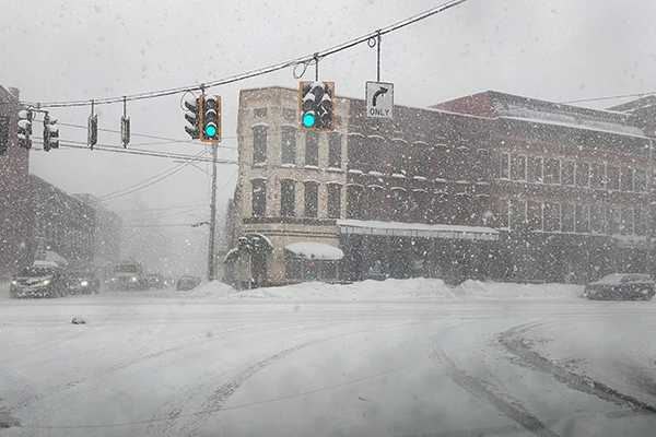 Snow blanketing intersection.