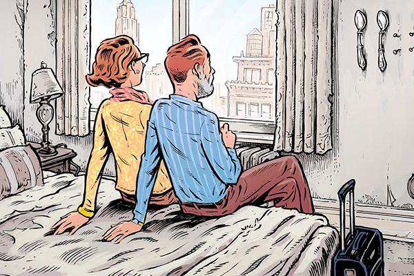 Couple sitting on a bed.