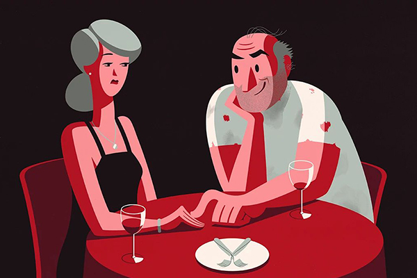 Couple sitting together at a table.