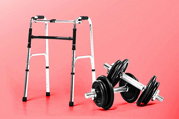 A walking frame next to a pair of dumbbells.