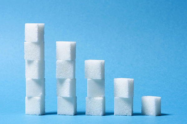 Stacks of sugar cubes at various heights.