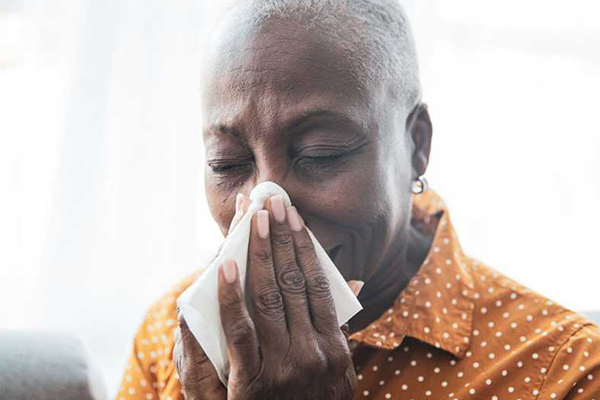 Person blowing their nose.