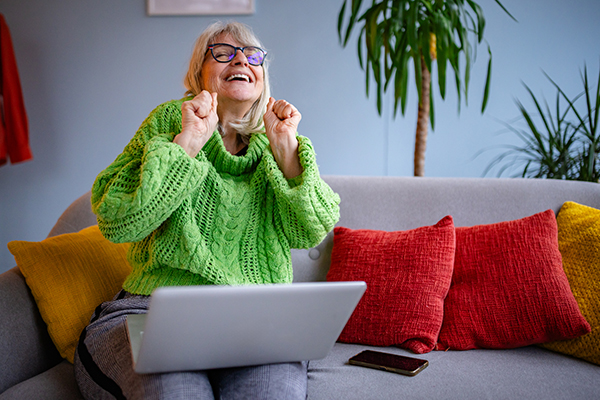 Excited person using a laptop.