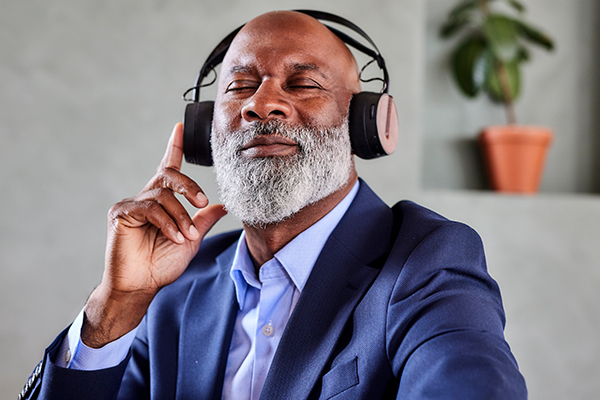 Person listening to music through headphones.