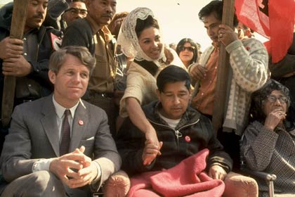 Robert F. Kennedy sits next to César Chávez (looking very weak after a prolonged hunger strike) during a rally in support of the United Farm Workers union in 1968.