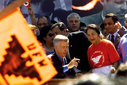 California Gov. Gray Davis, center, signs into law Senate Bill 984 that creates a new California state holiday honoring United Farm Workers (UFW) founder César E. Chávez, on August 18, 2000. The bill’s author, Sen. Richard G. Polanco, D-Los Angeles, is partially seen behind Davis. At right, Dolores Huerta, co-founder of the UFW.