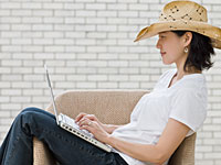 Self publishing a book is becoming easier with ebooks - a woman types on her laptop