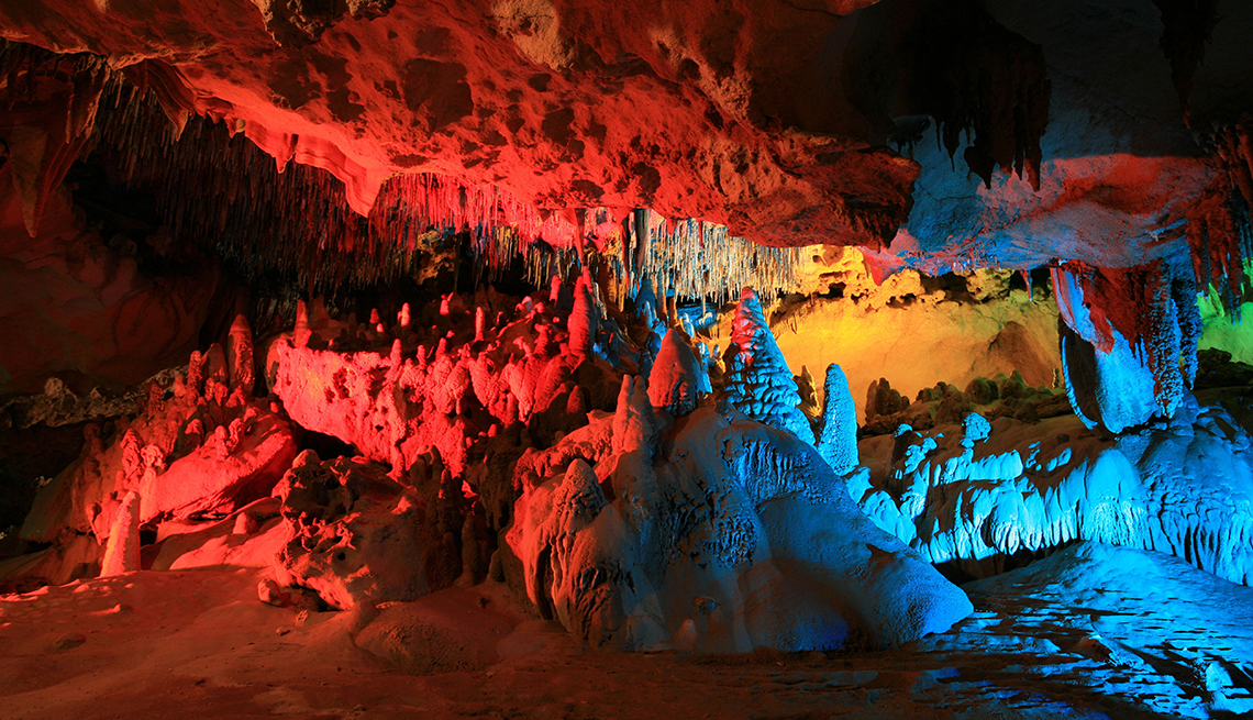 A cave in Florida lit up with red, blue, orange and green colors