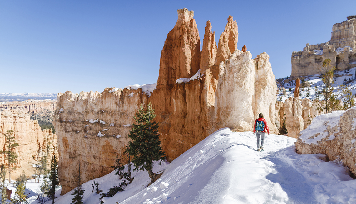 female hiker on a trail in Bryce Canyon National Park during winter