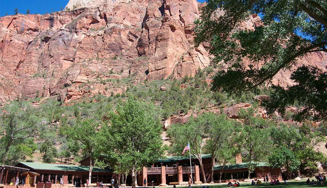 Low-angle view of tourists relaxing on the lawn of Zion Lodge at Zion National Park