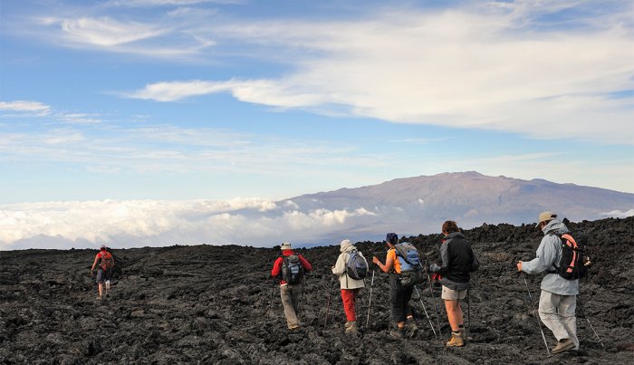 item 5 of Gallery image Group of hickers walking on cooled lava, Mauna Loa Volcano (Mauna Kea in the background), Big Island, Hawaii Islands