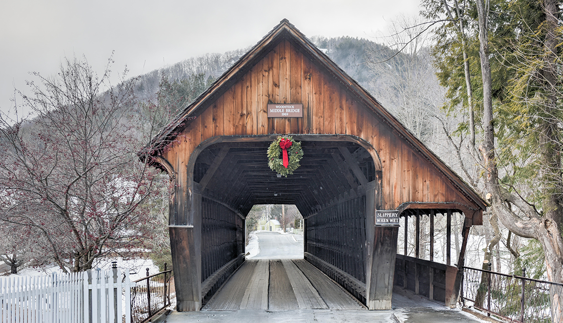 Middle Covered Bridge in Woodstock, Vermont in winter with surrounding snow