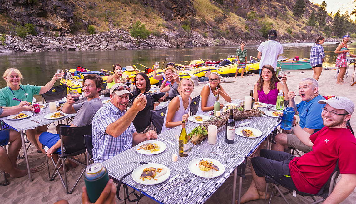 group of travelers eating salmon for the Salmon Six-Day River Rafting Utah trip