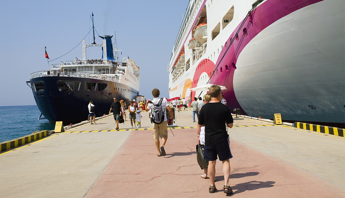 passengers boarding and leaving docked cruise ship