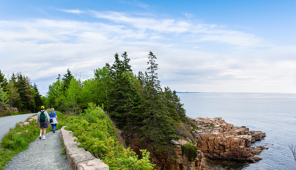 Walkers on path along the coast in Acadia National Park