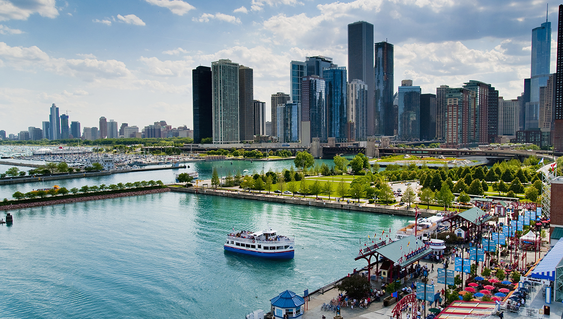item 9 of Gallery image - aerial view of the navy pier with a boat in the chicago harbor and skyscrapers in the background