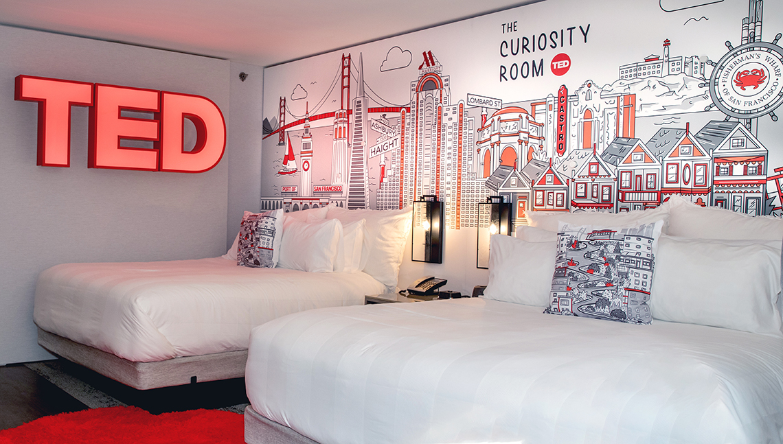 item 6 of Gallery image - the curiosity hotel room by ted in the marriott marquis san francisco shows a wall mural behind two beds and a neon ted sign on the other wall