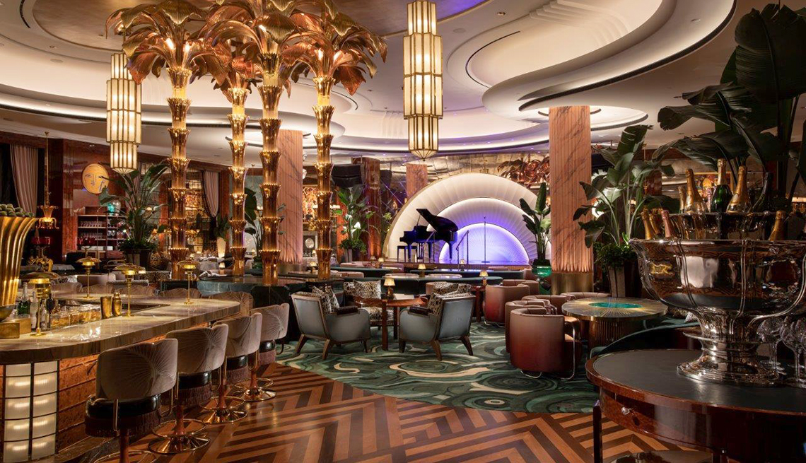 item 5 of Gallery image - art deco inspired delilah lounge and supper club at the wynn resort las vegas showing a sumptous bar tables and a stage with grand piano