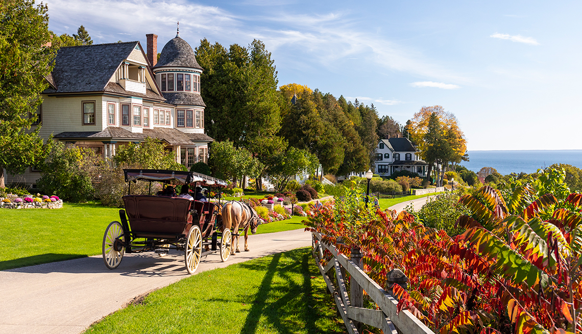 https://cdn.aarp.net/content/dam/aarp/travel/destinations/2023/10/1140-mackinac-island-michigan-horse-carriage.jpg