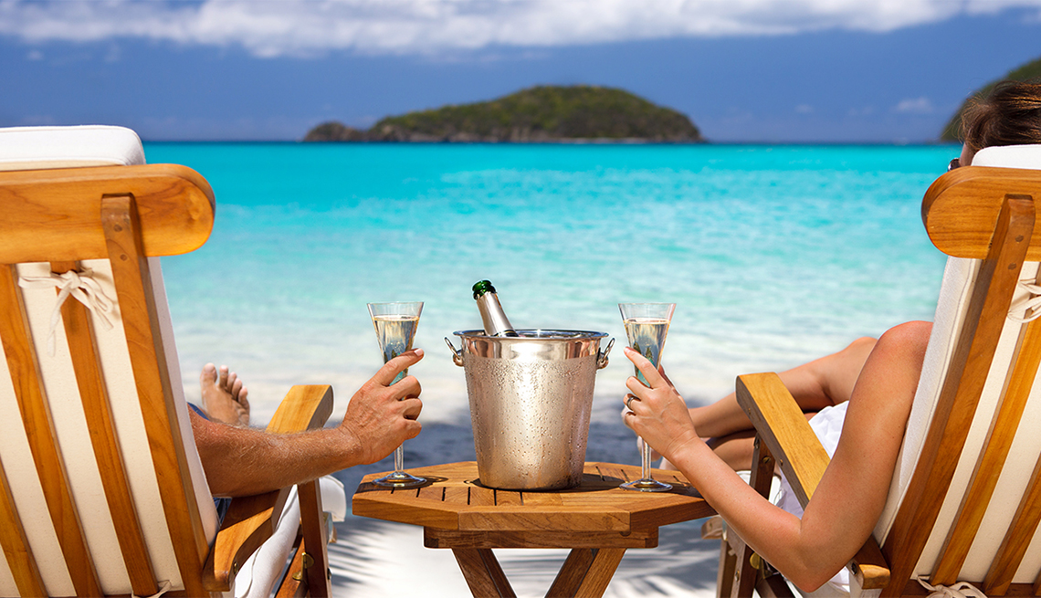 Couple in Recliners Enjoying Champagne on Beach, Caribbean Island Guide