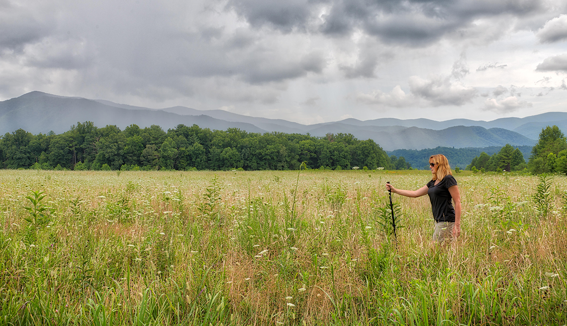 Woman walking on a cloudy day in the meadows at the Great Smoky Mountains