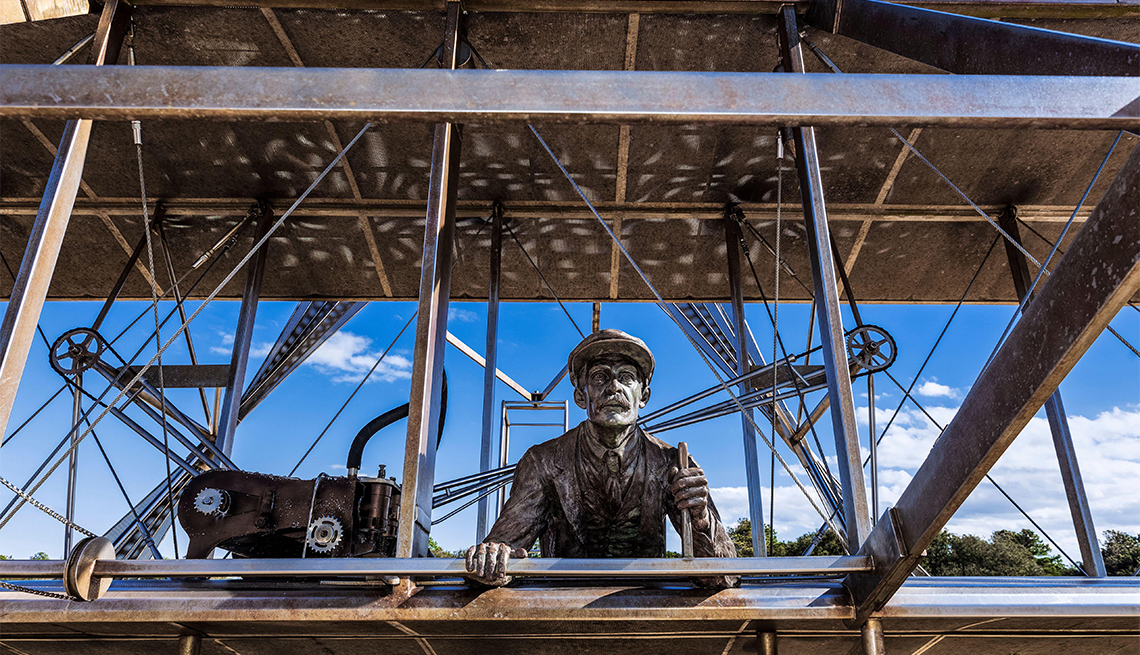 Sculpture of historic first flight at Wright Brothers National Memorial in Kill Devil Hills.