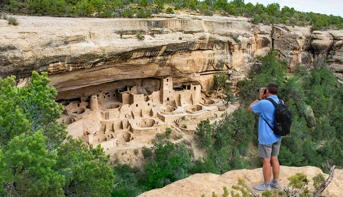 Tourist at Mesa Verde National Park photographing Cliff House