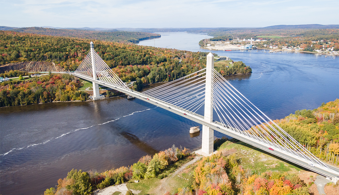 Drone view of the Penobscot Narrows Bridge and beautiful fall foliage near Belfast, Maine.