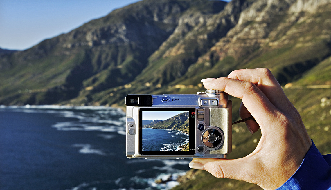 Hand Holds Digital Camera, Mountains and Ocean Waves, 5 Tips for Taking Vacation Photos