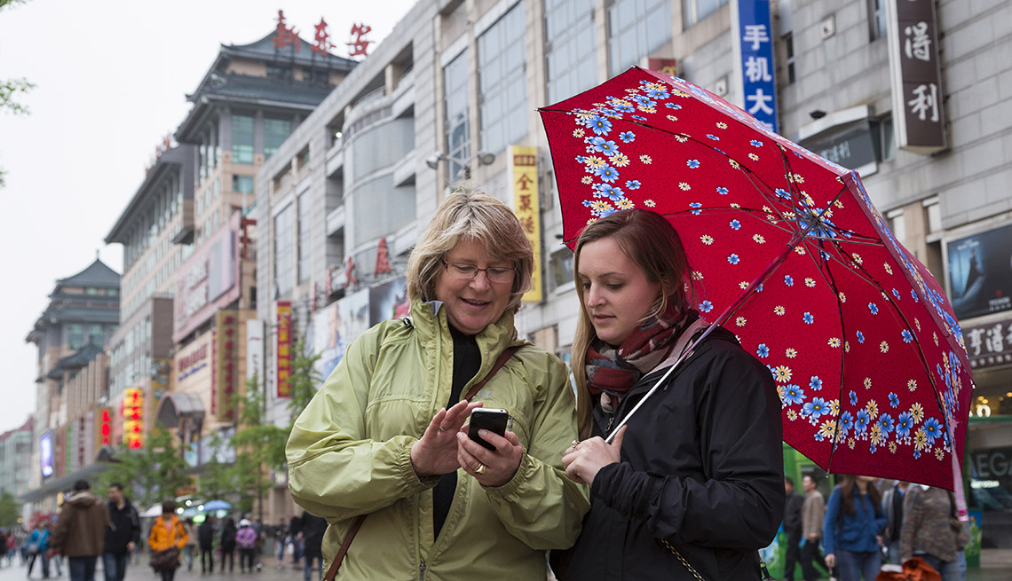 Mother And Adult Daughter Look At Their Cell Phones In Bejing China Spending Quality Time Together, Quality Time With Your Grownup Kids