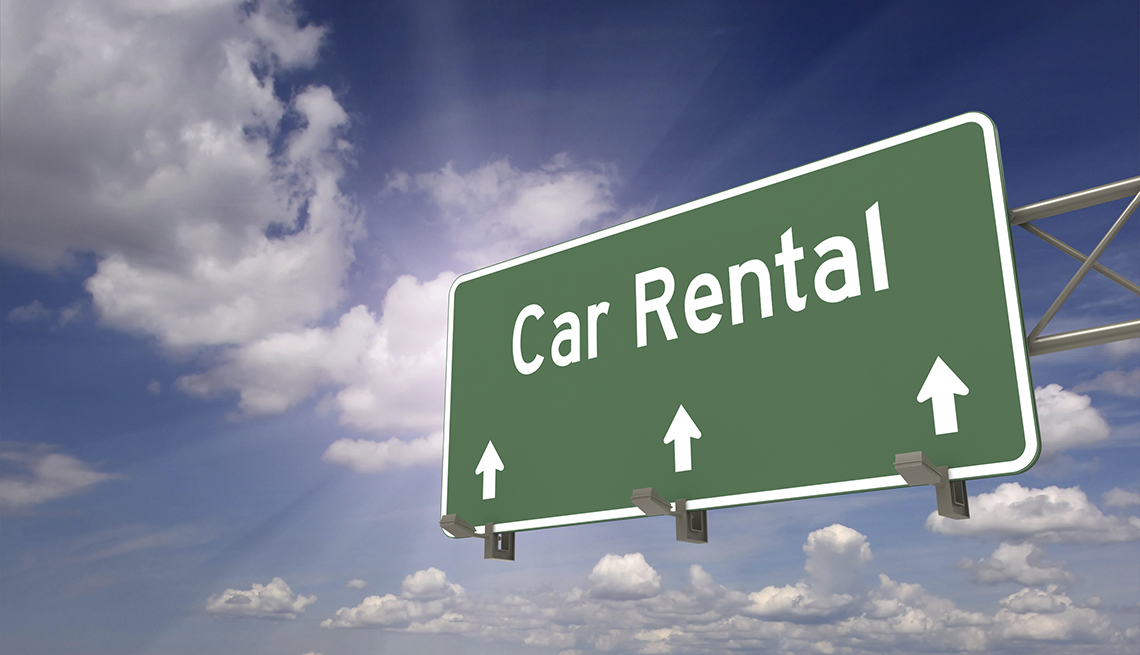 A Car Rental Direction Sign, Clouds, Tips for Stretching Your Car Rental Dollars