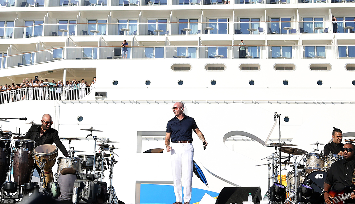 Musicians performing on a stage on the deck of a cruise ship