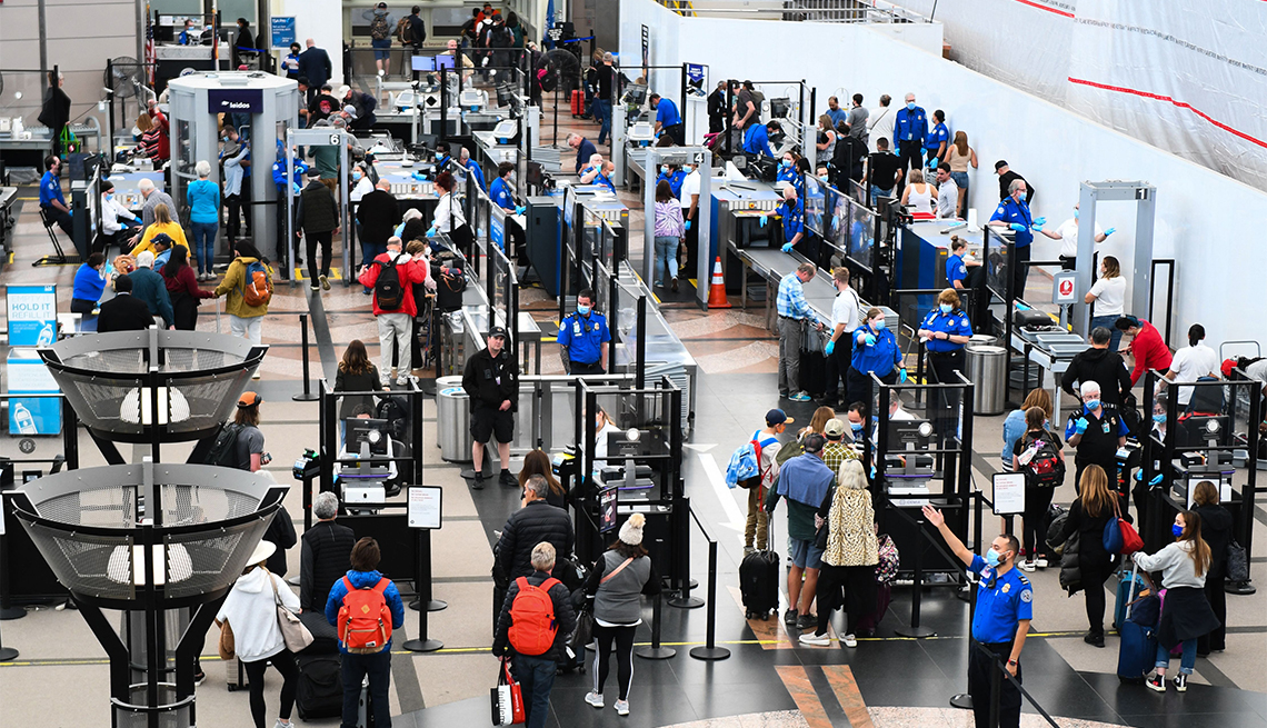 airline passengers stand in security lines at Denver International Airport