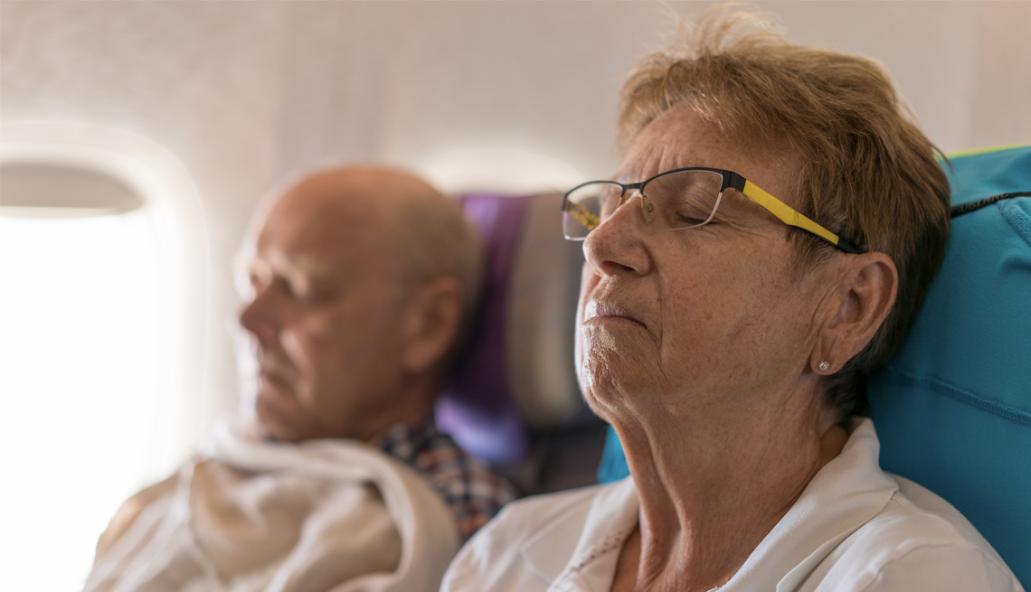 couple asleep on an airplane