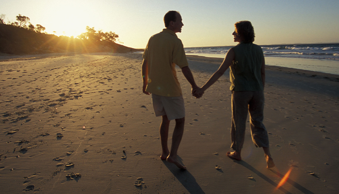 item 2 of Gallery image - A Couple Holds Hands And Walks On The Beach At Sunset In North Stradbroke Island In Queensland Australia, Under The Radar Destinations