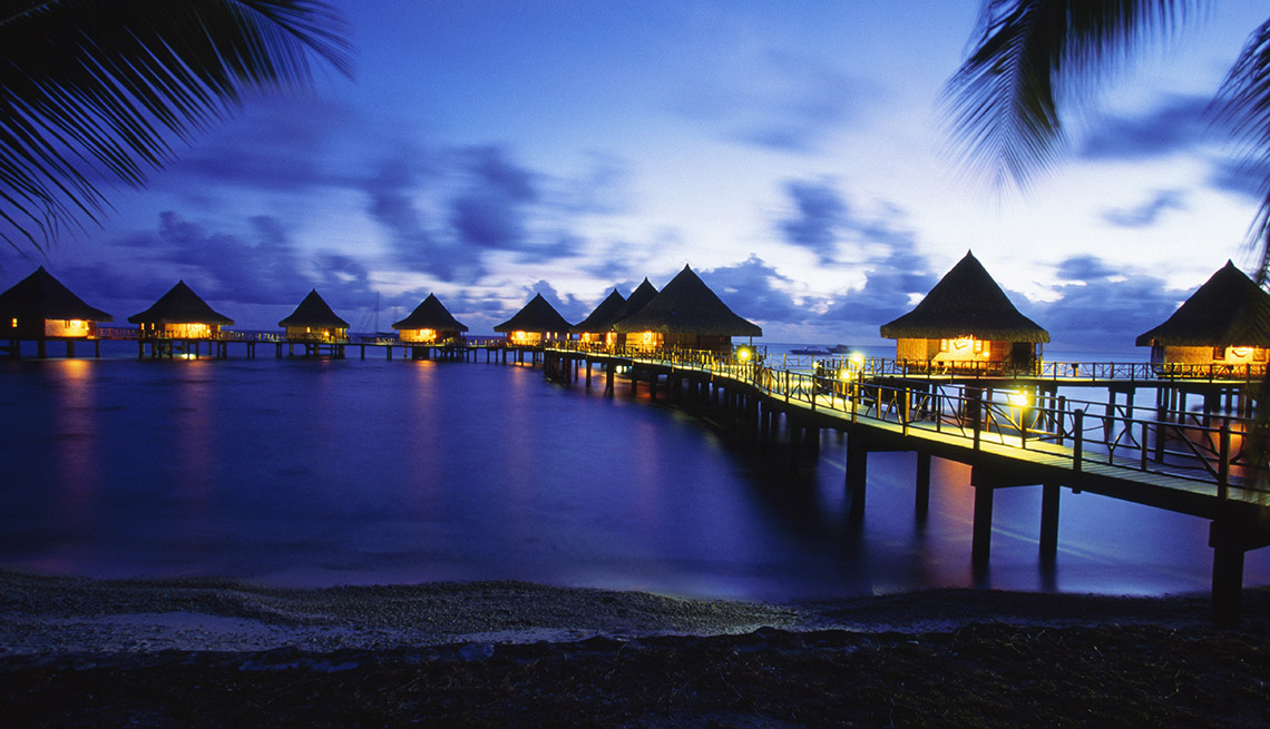 item 6 of Gallery image - Night Time At A Resort In Rangiroa Atoll In French Polynesia With Bungalows Over The Water, Under The Radar Destinations