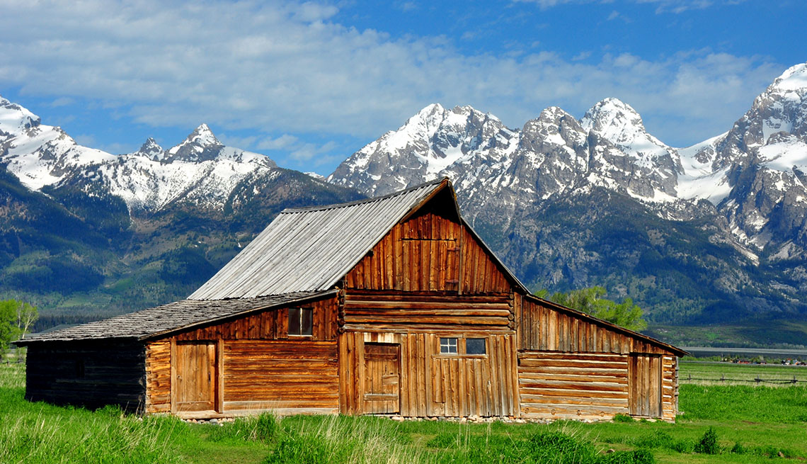 A Wood Cabin In Front Of The Grand Tetons Wyoming, Best National Parks