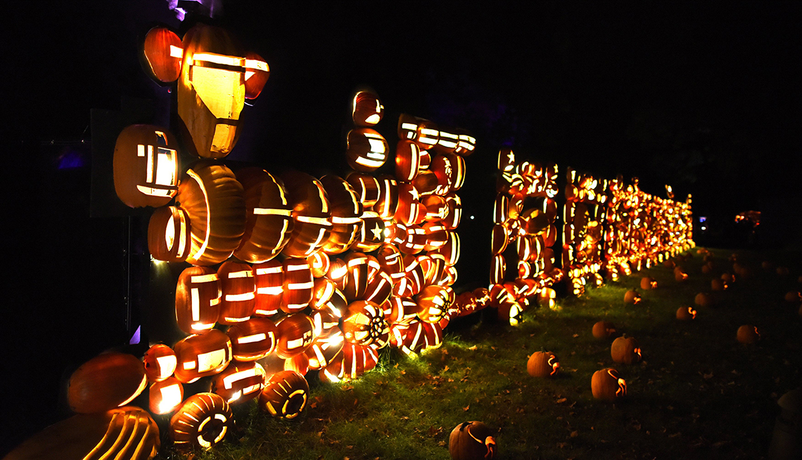 Illuminated pumpkins in the shape of a train displayed at Van Cortlandt Manor 