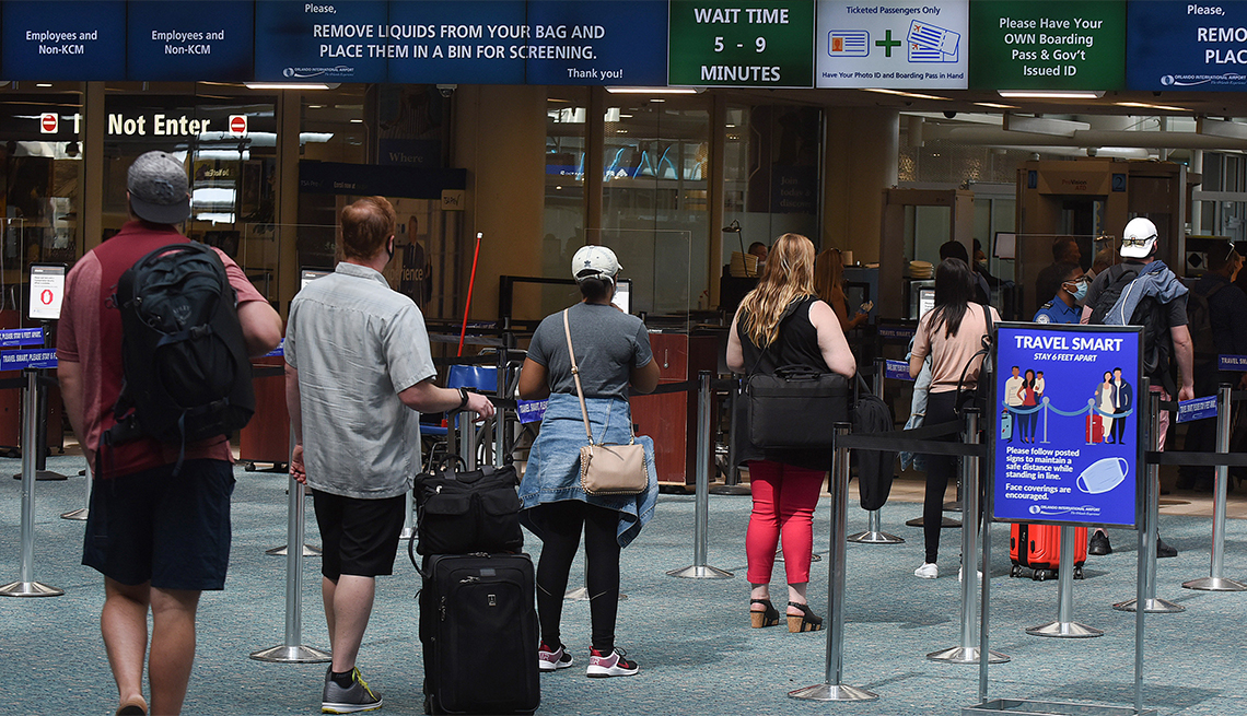 A sign reminding passengers to stay 6 feet apart is seen at a screening checkpoint at Orlando International Airport