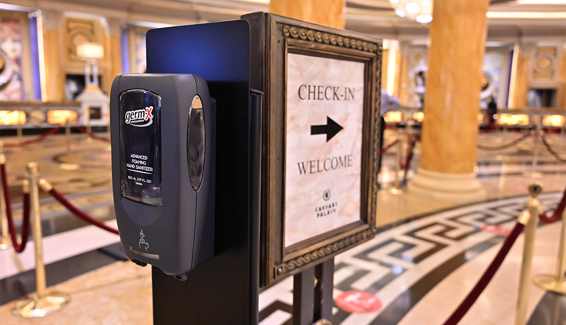 A hand sanitizer dispenser is posted is the lobby at Caesars Palace on the Las Vegas Strip