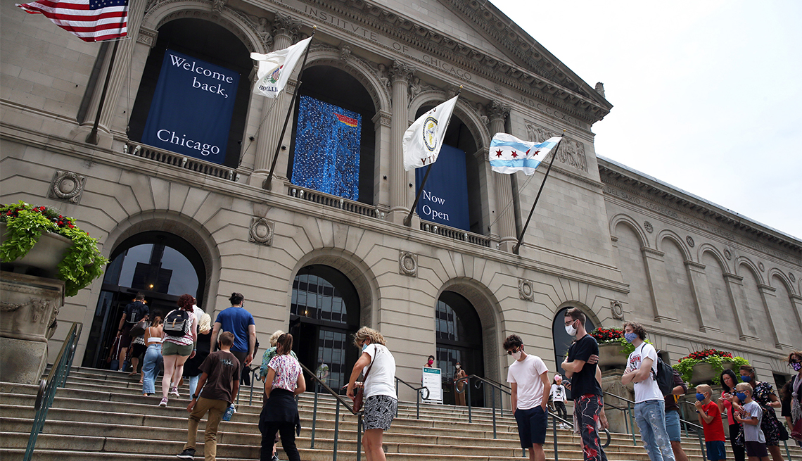 People line up outside the Art institute of Chicago as the museum re-opens on Thursday, July 30, 2020 in Chicago