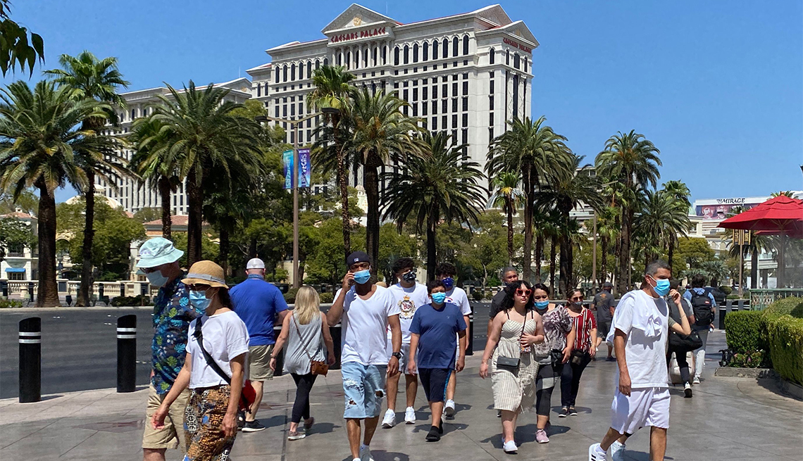 Tourists are wearing masks as they walk on the Strip in Las Vegas