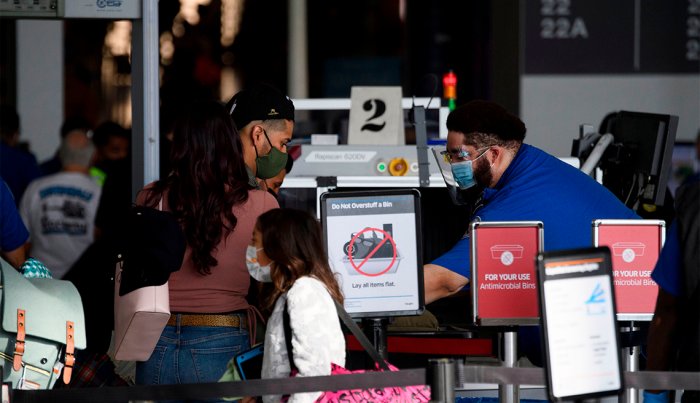 A passenger enters a Transportation Security Administration (TSA) checkpoint during the Covid-19 pandemic at Los Angeles International Airport