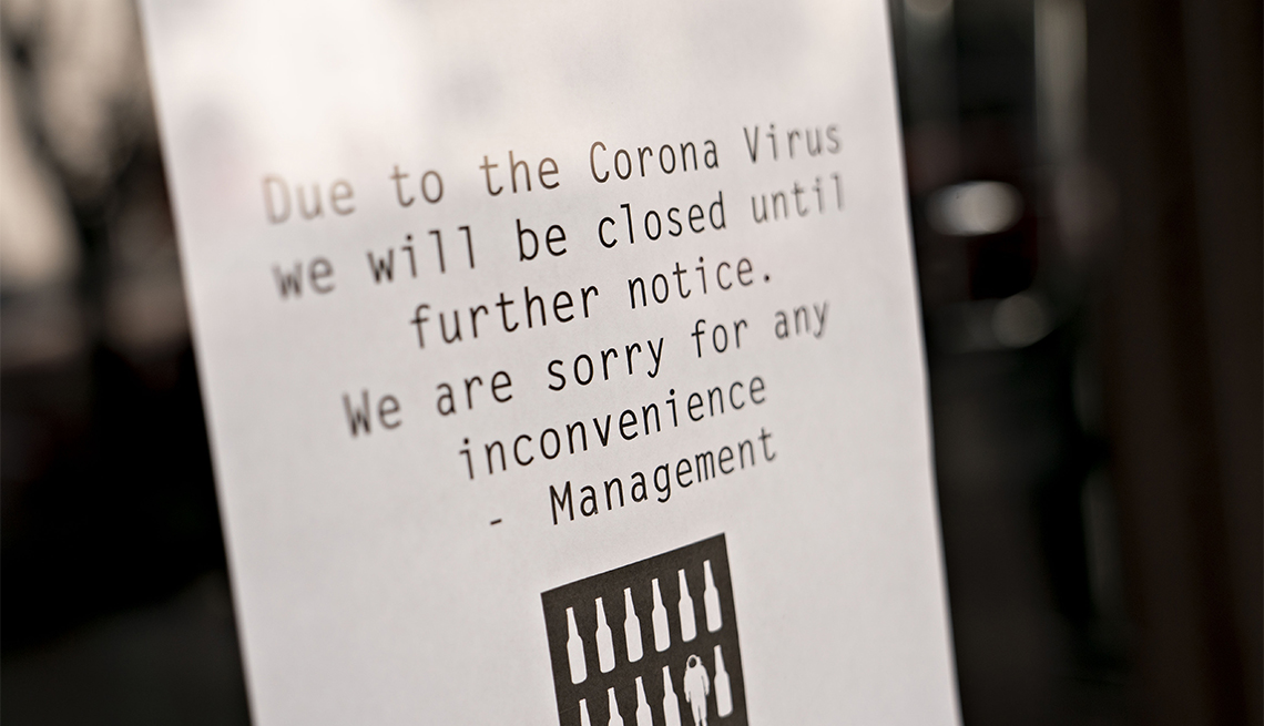 A sign alerts bar customers that it is closed due to Coronavirus 