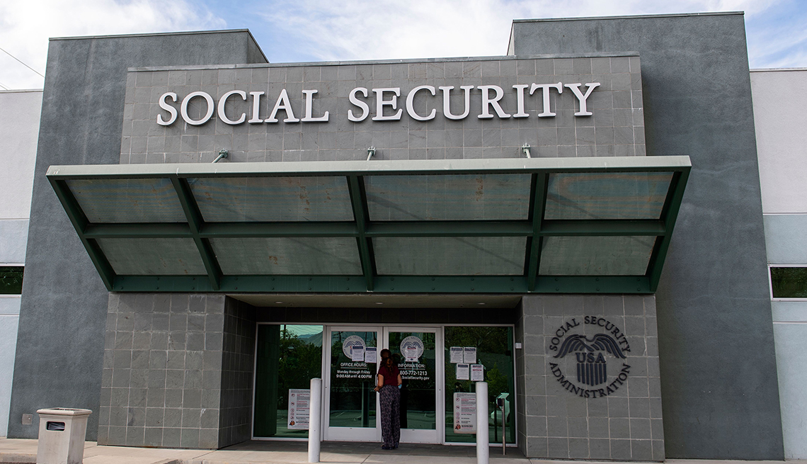 A woman stands outside a US Social Security Administration building, November 5, 2020, in Burbank, California. 