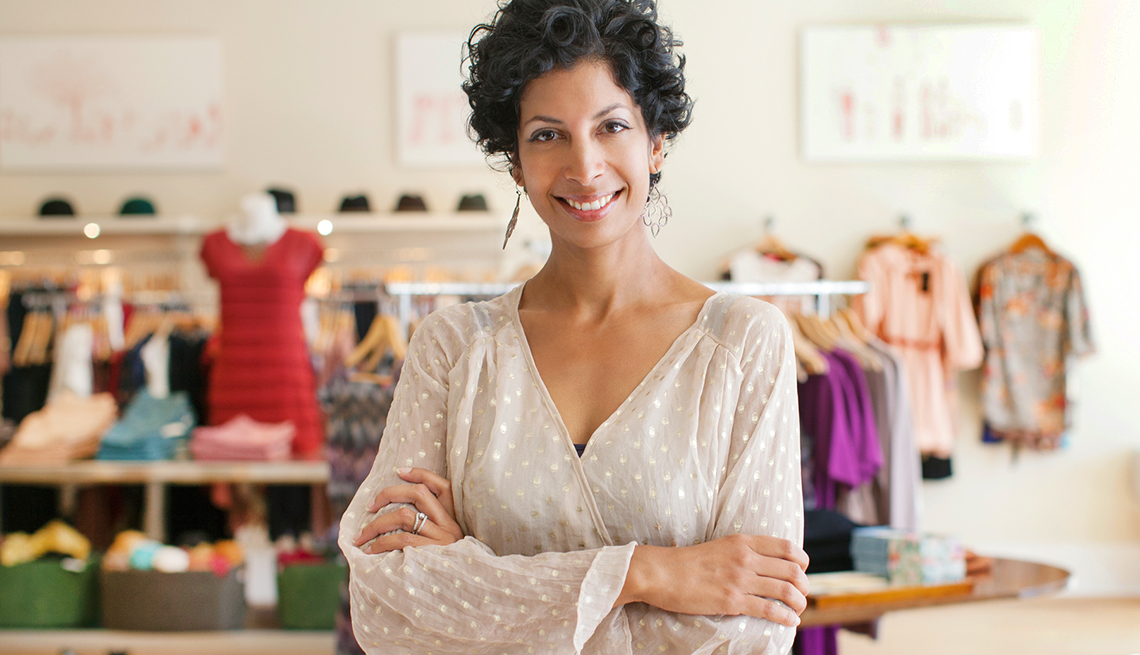 an older small business owner in her boutique