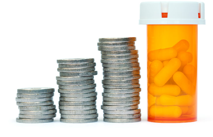 Coins stacked with pill bottle, Health Savings Accounts
