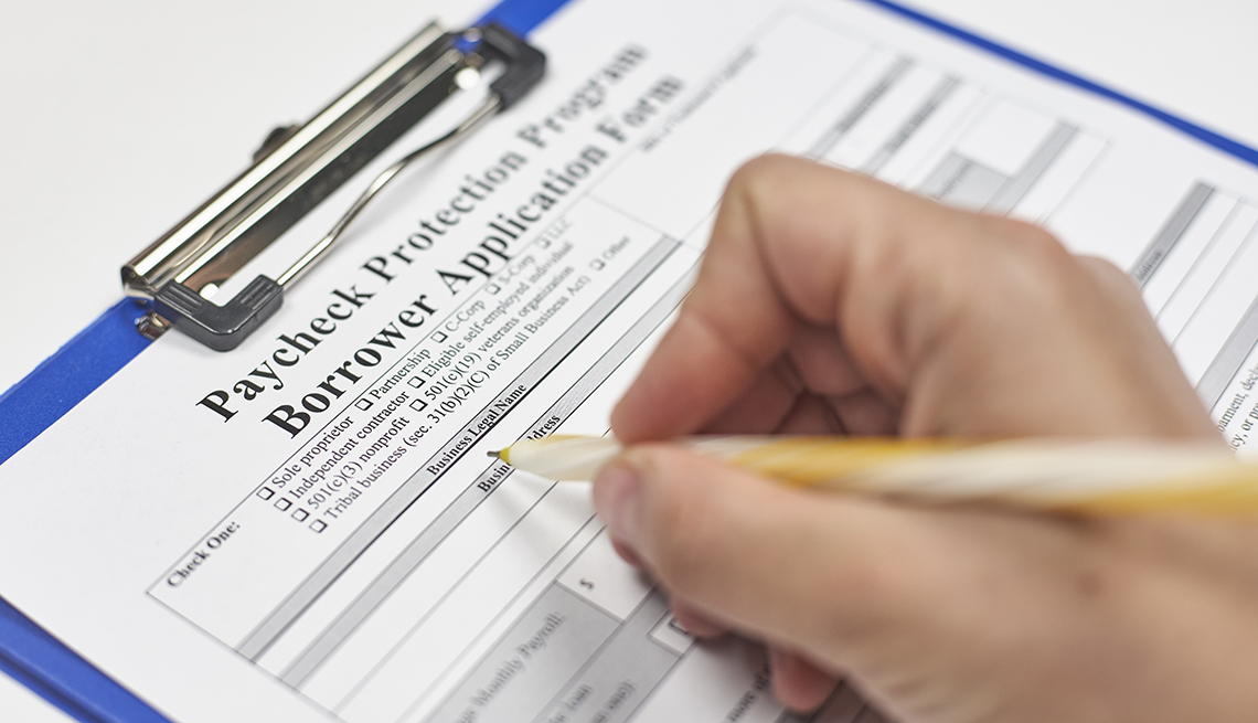A person filling a Paycheck Protection Program loan application.
