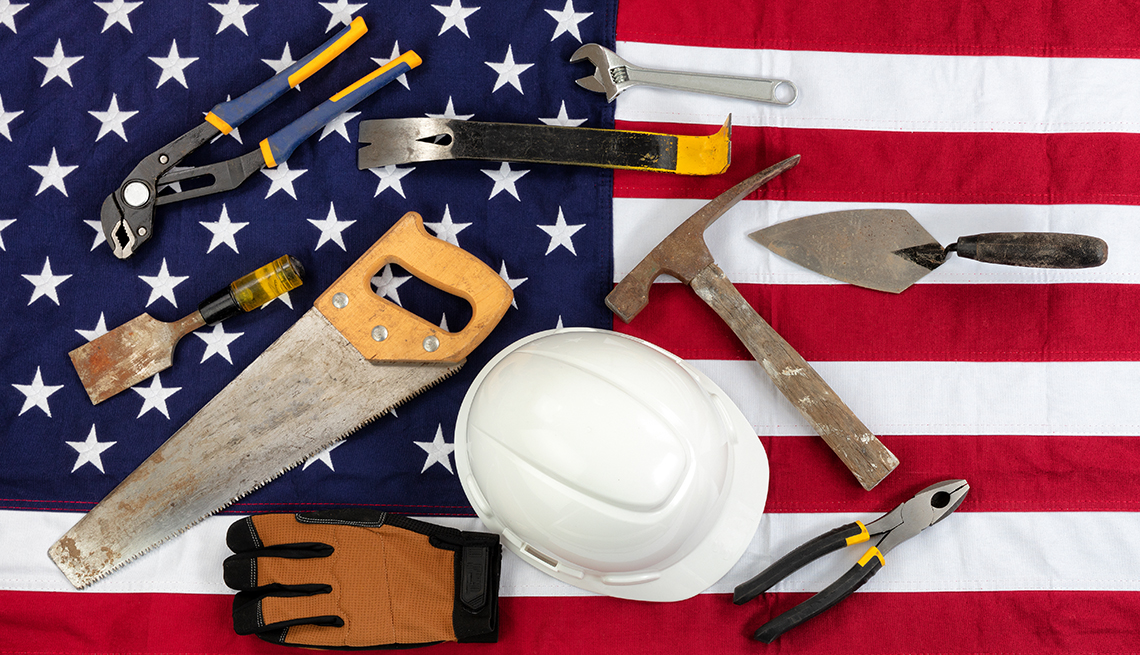 tools and a helmet on an american flag