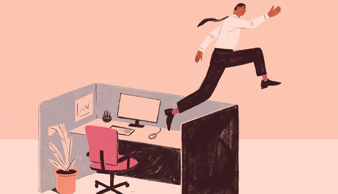 a man leaping over his work desk and out of his cubicle to freedom